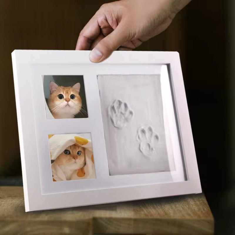 CJ supplier lifestyle image of the paw-impression frame; sample cat photos shown